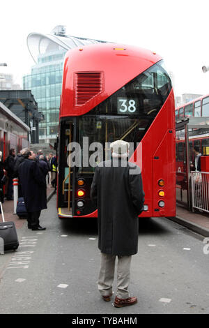 A man stares at London's new Routemaster double-decker bus at Victoria station on Friday on March 2, 2012. The new bus inspired by the old Routemaster is very expensive costing £1.5m ($2.4 million) per bus and has been criticized as a vanity project of the London Mayor Boris Johnson.     UPI/Hugo Philpott Stock Photo