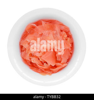 Pink pickled ginger in a white porcelain bowl isolated on a white background. Traditional Japanese condiment for sushi. Healthy eating.Top view. Stock Photo