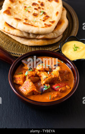 Food concept homemade Tandoori Chicken Masala curry with naan bread and yogurt dipping sauce with copy space Stock Photo