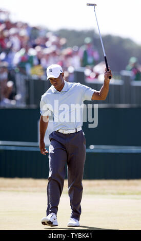 USA's Tiger Woods raises his club after getting a birdie on the 18th green on the second day of the 2013 Open Championship in Muirfield, Scotland on July 19 , 2013.       UPI/Hugo Philpott Stock Photo