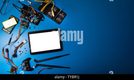 electronic items and digital tablet with blank screen on blue background with copy space Stock Photo