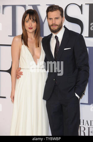 American fashion model and actress Dakota Johnson and Northern Irish actor and model Jamie Dornan attend the UK Premiere of 'Fifty Shades Of Grey' at Odeon Leicester Square in London on February 12, 2015.     UPI/Paul Treadway Stock Photo