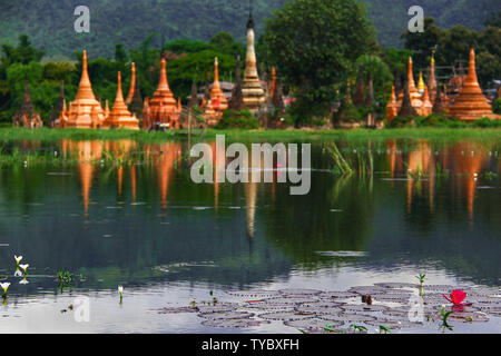 Lotus Flower Blossom with ancient Buddhist Pagodas in the background on the Inlay Lake in Burma/Myanmar. Stock Photo