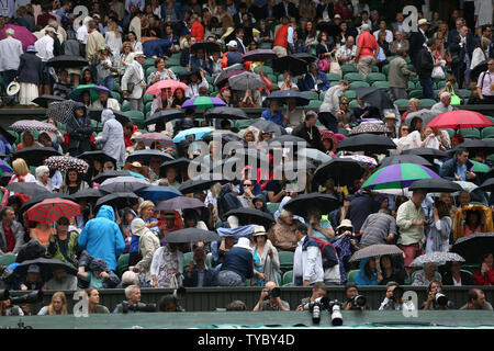 Rain stops play on centre court in the match between Great Britain's Andy Murray and Canada's Vasek Pospisil on day nine of the 2015 Wimbledon championships, London on July 08, 2015.      Photo by Hugo Philpott/UPI. Stock Photo