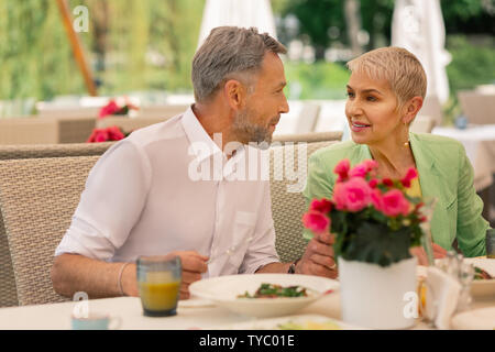Loving grey-haired mature man looking at his beautiful wife Stock Photo