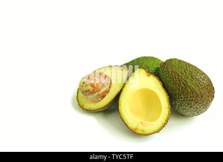 Fresh ripe avocado whole fruits and cut in half isolated on white background with copy space Stock Photo