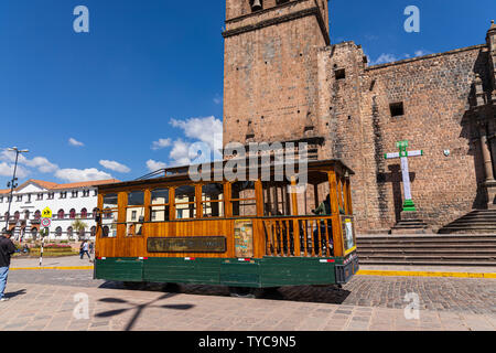 Old wooden tramcar in front of the Templo de San Francisco de Assisi, Church of Saint francis of assisi in the Plaza de San Francisco, Cusco, Peru, So Stock Photo