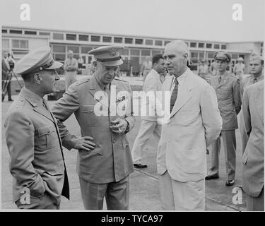 Photograph of General Dwight D. Eisenhower chatting with unidentified persons at the airport in Washington. Stock Photo