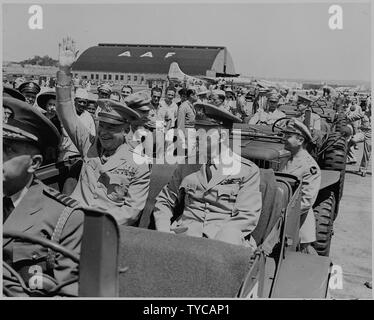 Photograph of General Dwight D. Eisenhower sitting in the back of a jeep with General George C. Marshall, waving to spectators at the airport in Washington. Stock Photo