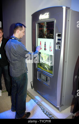Samsung Corporation displays their newest touch screen uVending machine as visitor Christopher Kopp makes a selection during the International Consumer Electronics Show (CES) in Las Vegas on January 8, 2009.  This uVending machine was stocked with Coca Cola products with many CES visitors waiting in line to try the new vending machine technology.  The 2009 CES opened to the public on Thursday and continues through the weekend. (UPI Photo/Tom Theobald) Stock Photo