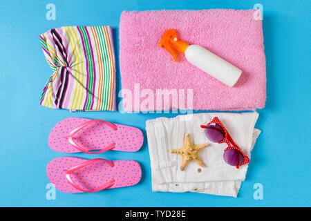 Flat lay composition with Beach accessories on blue color background. Summer holiday background. Vacation and travel items top view. Stock Photo