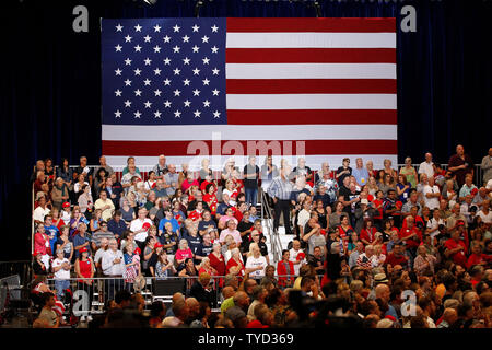 Attendees stand before President Donald Trump arrives to speak during a ...