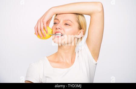 Girl drink fresh juice whole lemon fruit. Healthy lifestyle and organic nutrition. Lemonade fills you with energy. Battery concept. Lemon with hobnail natural battery. Recharge your body vitamins. Stock Photo