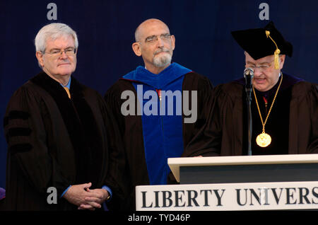 Former Speaker of the House Newt Gingrich (R-GA) (L) and Liberty Executive Vice President Dr. Ronald Godwin (C) listen as Liberty Provost Dr. Boyd Rist speaks before presenting Gingrich with an honorary degree during commencement ceremonies at Liberty University in Lynchburg, Virginia on May 19, 2007.  (UPI Photo/Alexis C. Glenn) Stock Photo