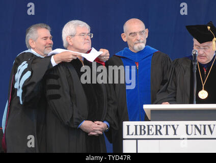 Vice Provost of Graduate and Distant Learning Studies Dr. Ron Hawkins (L) places a hood around Former Speaker of the House Newt Gingrich (R-GA) (2nd L) as Liberty Provost Dr. Boyd Rist (R) awards  an honorary degree to Gingrich from Liberty University during commencement ceremonies in Lynchburg, Virginia on May 19, 2007. Liberty Executive Vice President Dr. Ronald Godwin (2nd R) listens. (UPI Photo/Alexis C. Glenn) Stock Photo