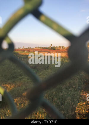 The Mexico-U.S. border fence is seen from the Gateway international bridge between Matamoros, Mexico and Brownsville, Texas looking into the U.S. on January 10, 2019, the day of President Trump's visit to the Border in Brownsville, Texas. A Border Patrol vechicle sits in the distance.  Photo by Patrick Timmons/UPI Stock Photo