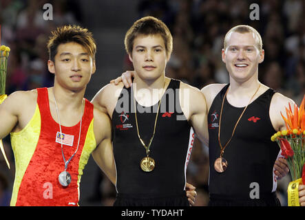Medalists gather following the men's gymnastics floor exercise finals at the XVIII Commonwealth Games in Melbourne, Austraiia on March 20, 2006. Canadian Adam Wong, 20, of Calgary (center), won the gold medal with a score of 14.975 points ahead of Shu Wai Ng of Malaysia (left, silver, 14.850 points), and Canada's Olympic champion Kyle Shewfelt (right, bronze, 14.700 points).  (UPI Photo/Grace Chiu). Stock Photo