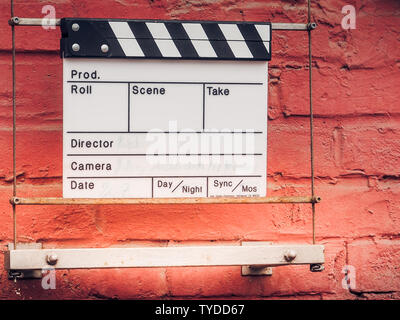 Ciak or clap board on a wall. Film movie titles. Abstract image for cinema. Can be applied to concepts like startup, start, beginning, new ideas. Busi Stock Photo