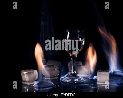 Fire on the wine glass, fire on the cocktail glass , vodka ice and fire. Stock Photo