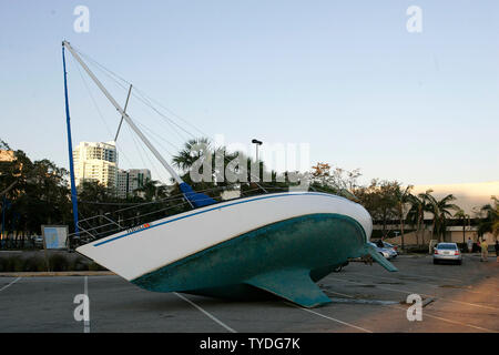 A sail boat lies in the Dinner Key Marina parking lot, lifted out of Biscayne Bay by category 3 Hurricane Wilma in Coconut Grove, Florida on October 25, 2005.  (UPI Photo/Michael Bush) Stock Photo