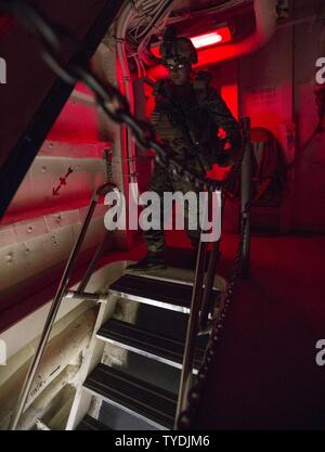 U.S. Marine Sgt. Evan Arce heads to a staging area, in preparation for a raid, aboard the USS Green Bay (LPD 20), during Blue Chromite 2017 in Okinawa, Japan, November 2, 2016. Blue Chromite is a U.S. –only exercise which strengthens the Navy-Marine Corps expeditionary, amphibious rapid-response capabilities based in Okinawa and the greater Indo-Asia-Pacific region. Arce is with 3rd Battalion, 3rd Marine Regiment which is forward deployed from Kaneohe Bay, Hawaii, to 3rd Marine Division, based in Okinawa, Japan. Stock Photo