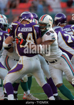 Miami Dolphins defensive end Jason Taylor (99) runs for a 20-yard touchdown  after intercepting a pass thrown by Chicago Bears quarterback Rex Grossman  during the second quarter at Soldier Field in Chicago