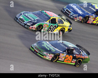 Carl Edwards 60 and Jeff Burton 29 run through turn four during