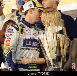 Jimmie Johnson and his wife Chandra celebrate winning the 2007 NASCAR Nextel Cup championship with a kiss, after Johnson finished seventh in the Nextel Cup Ford 400 at Homestead-Miami Speedway in Homestead, Florida on November 18, 2007.   (UPI Photo/Michael Bush) Stock Photo