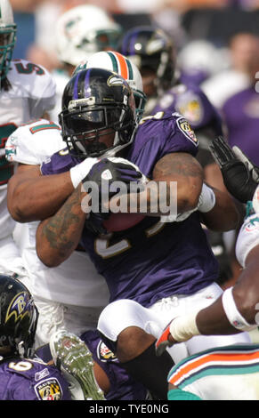 Baltimore Ravens running back Willis McGahee (23) rushes for a four yard gain and is tackled by Miami Dolphins defensive end Phillip Merling (97) during the AFC Wild  Card playoff game in Miami, Florida on January 4, 2008. The Ravens defeated the Dolphins 27--9. (UPI Photo/Susan Knowles) Stock Photo