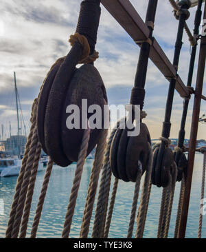 Old wooden deadeye on the shrouds of a sailing ship. Stock Photo