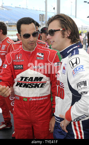 Indy car drivers Helio Castroneves (L) and Dan Weldon talk during pre-race activities prior to the IRL Firestone Indy 300 at Homestead-Miami Speedway in Homestead, Florida on October 10, 2009.   UPI/Michael Bush Stock Photo