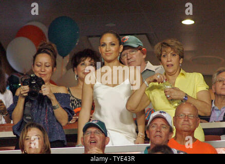 Latin recording artist and minority owner of the Miami Dolphins Jennifer Lopez (C) enjoys the game against the New York Jets at Landshark stadium in Miami on October 12, 2009.  The Dolphins defeated the Jets 31-27.  UPI/Michael Bush Stock Photo