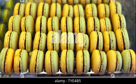 Fench macarons background close up. Tasty sweet color macarons as bakery concept. Selective focus. . Sweet macarons in plastic box for sale. Food back Stock Photo