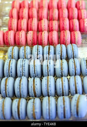 Fench macarons background close up. Tasty sweet color macarons as bakery concept. Selective focus. . Sweet macarons in plastic box for sale. Food back Stock Photo