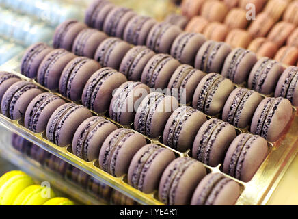 Fench macarons background close up. Tasty sweet color macarons as bakery concept. Selective focus. . Sweet macarons in plastic box for sale. Food back Stock Photo