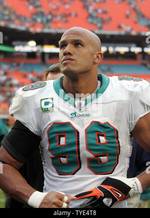 Miami Dolphins linebacker Jason Taylor (99) is escorted off the