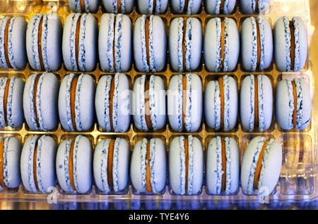 Fench macarons background close up. Tasty sweet color macarons as bakery concept. Selective focus. . Sweet macarons in plastic box for sale. Food back Stock Photo