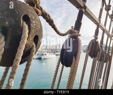 Old wooden deadeye on the shrouds of a sailing vessel of the eighteenth century. Stock Photo