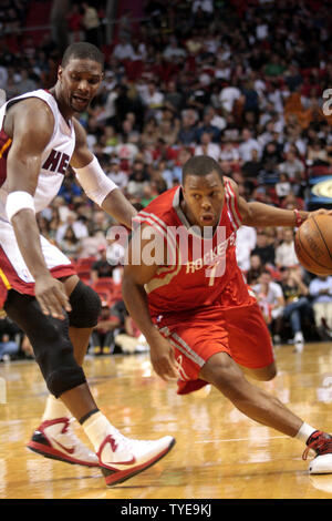 Houston Rockets Guard  Kyle Lowry (7) drives against Chris Bosh (1)  during first half action against the Houston Rockets at the American Airlines Arena, in Miami Florida March 27th, 2011. The Miami Heat beat the Houston Rockets 125-119..                                                    UPI/Susan Knowles... Stock Photo