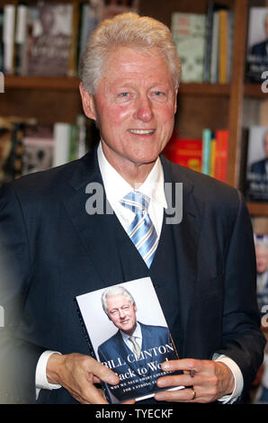 Former US President Bill Clinton signs copies of his new book 'Back to Work' at Books and Books in Coral Gables Florida on December 1, 2011. UPI/Michael Bush Stock Photo
