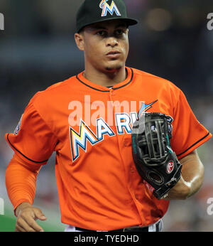 Miami Marlins center fielder Giancarlo Stanton returns to the dugout after  the second inning against the New York Yankees in their first exhibition  game at the new Marlins Ball Park April 1