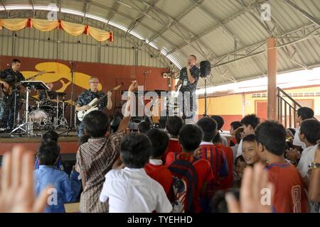 SIHANOUK VILLE, Cambodia (Nov. 4, 2016) The 7th Fleet Rock Band 'Orient Express' performs at M'Lop Tapang Orphanage as part of CARAT Cambodia. CARAT is a series of annual maritime exercises between the U.S. Navy, U.S. Marine Corps and the armed forces of nine partner nations to include Bangladesh, Brunei, Cambodia, Indonesia, Malaysia, the Phillipines, Singapore, Thailand, and Timor-Leste. Stock Photo