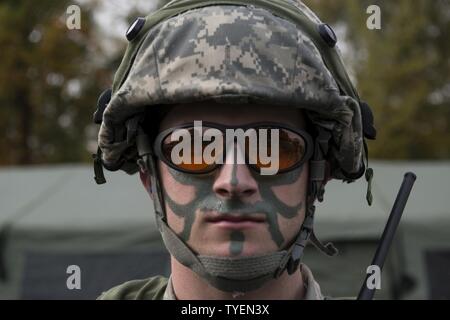 Senior Airman David DeSantis, 1st Combat Communications Squadron radio transmission systems technician, participates in exercise Healthy Thunder at Ramstein Air Base, Germany, Nov. 4, 2016. The Airmen put on face paint for the final battle of the field training exercise portion of Healthy Thunder, where opposing forces breached the base and Airmen defended it. Stock Photo