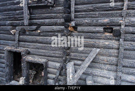The wall of the burned wooden house. Stock Photo