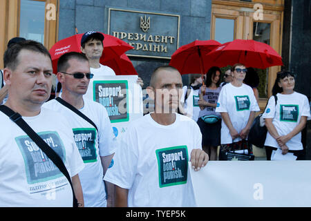Ukrainians wearing white in t-shirts reading Support, Don't punish take part  during a rally against repressive drug policies in front the Presidential Administration in Kiev.The rally was part of the global campaign 'Support, Don't punish' held in support of on the rights of drug addicted people and it was timed on the International Day against drug Abuse and Illegal Circulation and the International Day in Support of Victims of Torture, which of both are marked on 26 June. Stock Photo