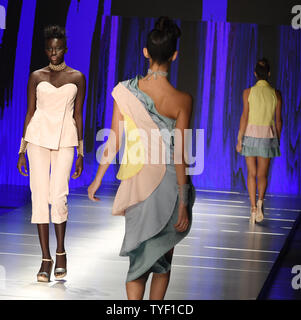 A runway model presents fashions by Rene RR during Miami Fashion Week ...