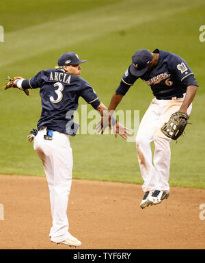 Milwaukee Brewers' Lorenzo Cain and Orlando Arcia smile during the