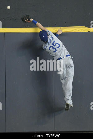 Los Angeles Dodgers outfielder Cody Bellinger leaps for Milwaukee Brewers shortstop Orlando Arcia's solo home run during the fifth inning in National League Championship Series game two at Miller Park on October 13, 2018 in Milwaukee.  The Brewers lead the series 1-0 over the Dodgers.  Photo by Brian Kersey/UPI Stock Photo