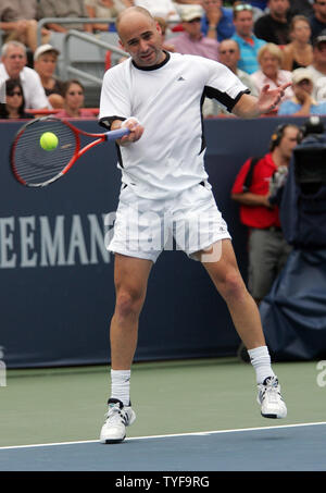 American Andre Agassi returns a shot to Spain's Rafael Nadal in the final match of the Rogers Cup men's tennis ATP masters tournament in Montreal on August 14, 2005. Nadal,19, defeated Agassi, 35,  6-3, 4-6, 6-2. (UPI Photo / Grace Chiu) Stock Photo