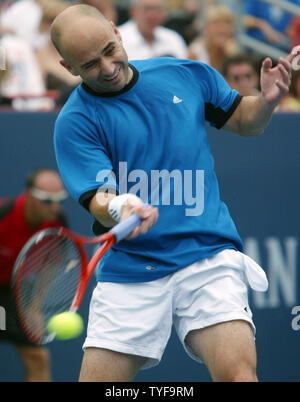 American Andre Agassi returns a shot to Spain's Rafael Nadal in the final match of the Rogers Cup men's tennis ATP masters tournament in Montreal on August 14, 2005. Nadal,19, won the tournament 6-3, 4-6, 6-2. (UPI Photo / Grace Chiu) Stock Photo